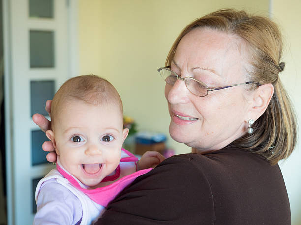 istock Grandmother holding a smiling baby 629446714