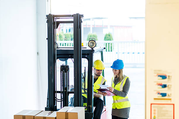 istock Forklift driver talking to a manager in the warehouse 629447582