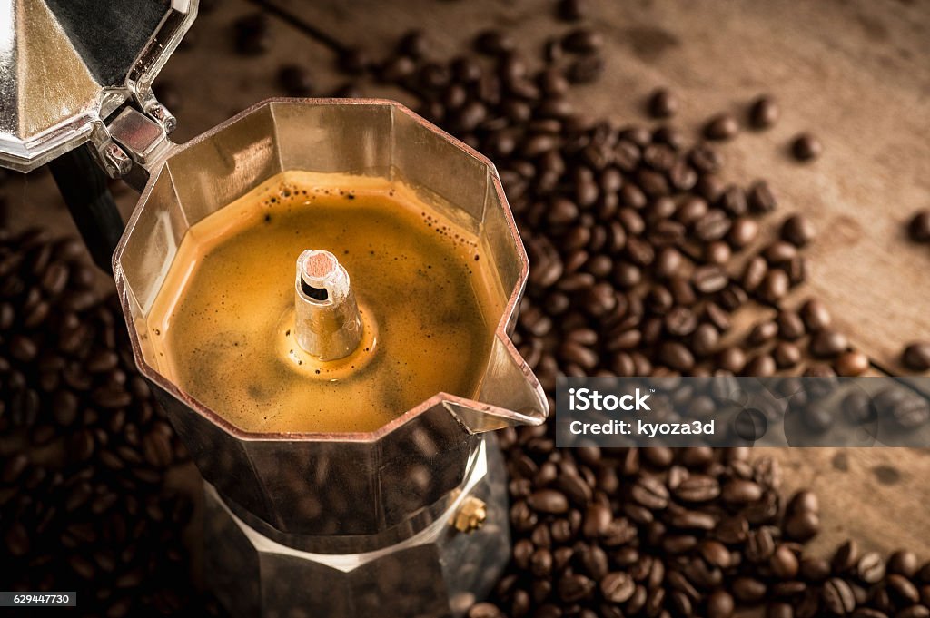 Moka pot old coffee maker and coffee beans Espresso in Moka pot old coffee maker and coffee beans Mocha Stock Photo