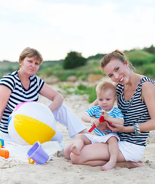 istock Happy family having fun at the beach 629448040