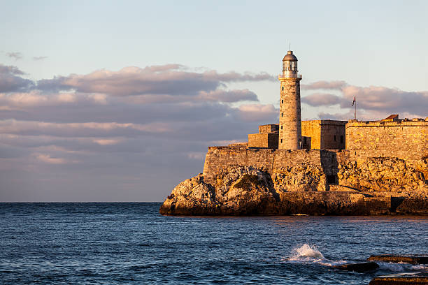 Lighthouse at sunset, havana, Cuba Lighthouse at Castillo del Morro, El Morro Fort in Havana at sunset morro castle havana stock pictures, royalty-free photos & images
