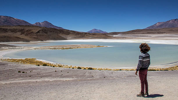 istock Guy with curly hair staring blue lagoon in Bolivia 629455592