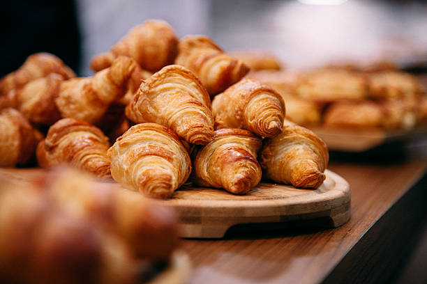 French Boulangerie - fresh croissant for sale Rows of fresh baked French croissants ready to be sold baguette photos stock pictures, royalty-free photos & images