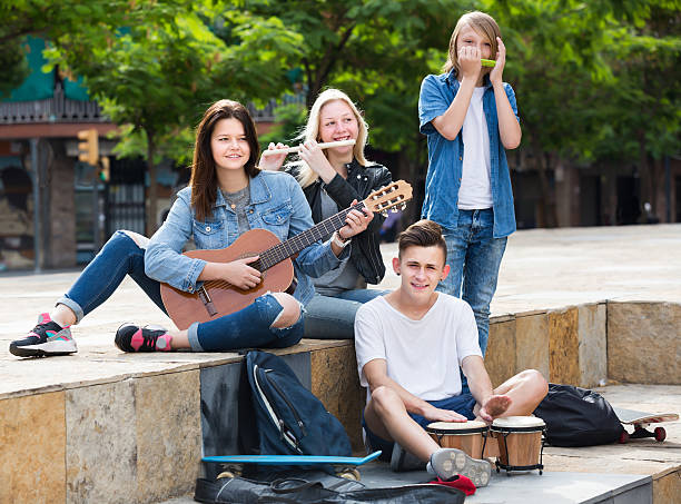 istock Glad girls and boys with musical instruments 629457314