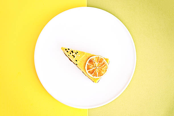 istock Flat lay of lemon cake cut on a colorful background 629457396