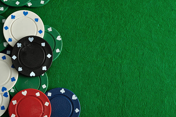 istock Poker chips forming a border with a green backgroun 629457974
