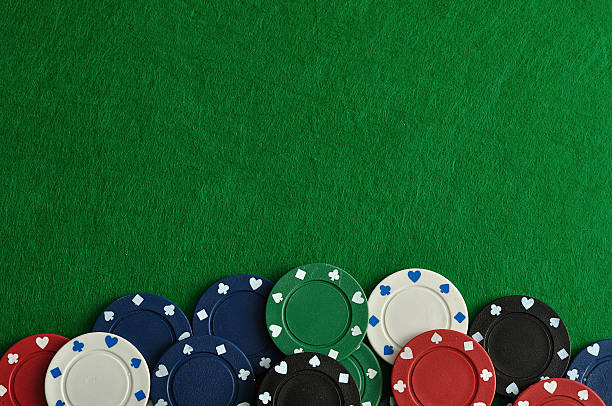 istock Poker chips forming a border with a green backgroun 629458352