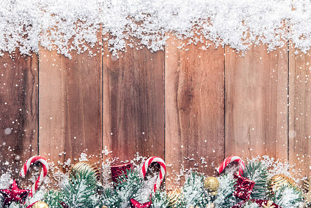 istock Christmas ornaments with snow on wood background 629481290