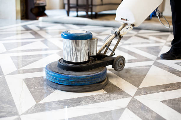 man polishing marble floor in modern office building stock photo