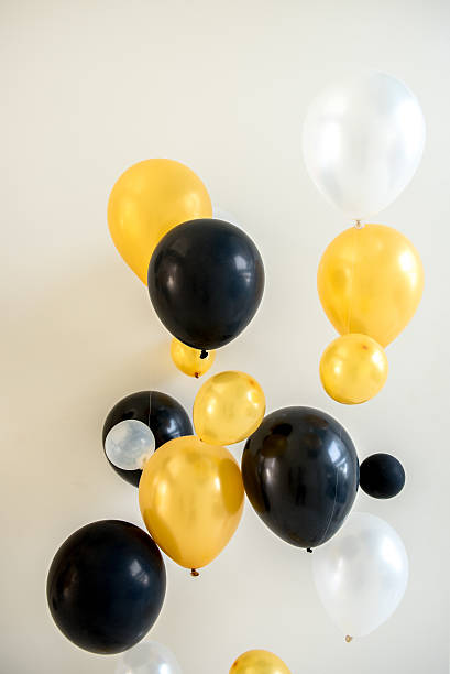 istock yellow white and black balloons 629484134