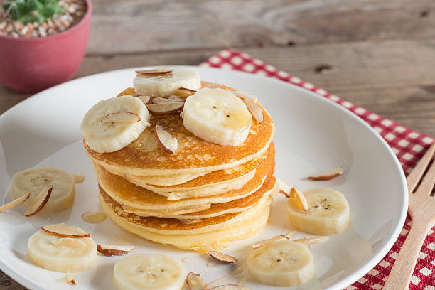 istock Pancakes with bananas almond and caramel sauce. selective focus. 629494418