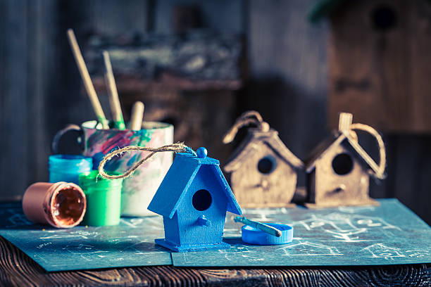 istock Vintage small bird feeder in wooden workshop 629495662