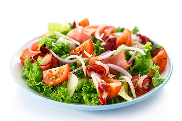 Vegetable salad with ham on white background stock photo
