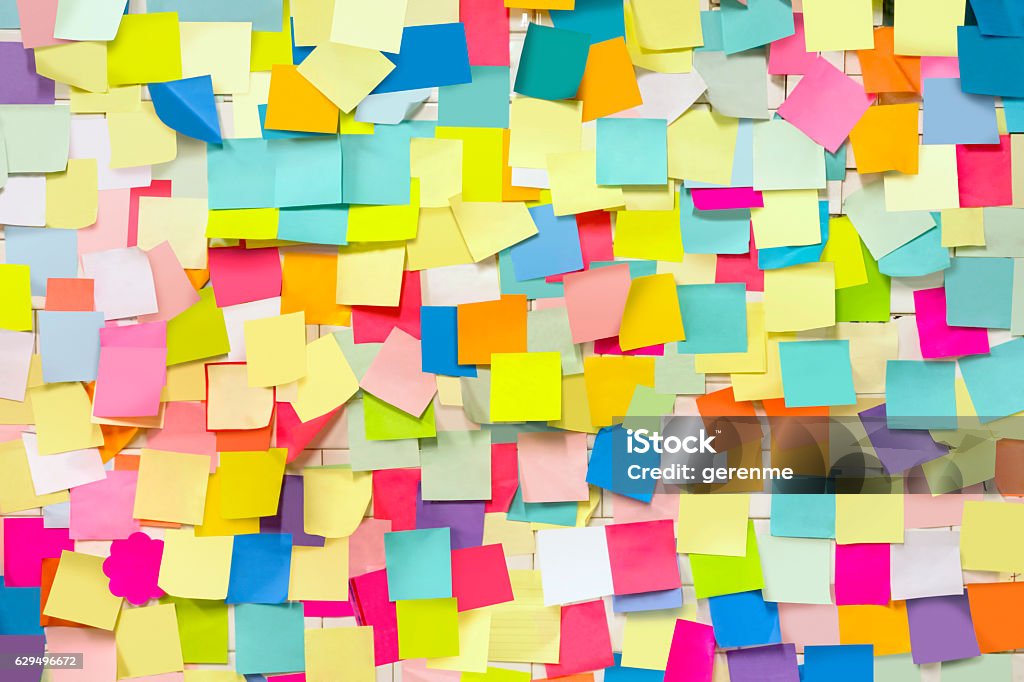Wall covered with adhesive note papers Wall covered with blank adhesive note papers Adhesive Note Stock Photo