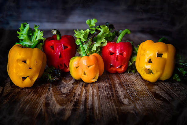 istock yellow sweet bell peppers with cutout faces 629507330