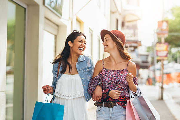 Best friend shopping frenzy Shot of two young friends enjoying a day of shopping mall walker stock pictures, royalty-free photos & images