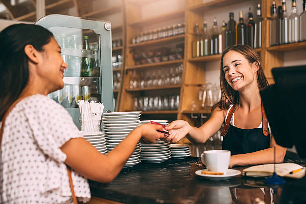 credit cards are welcome here - coffee serving cafeteria worker checkout counter imagens e fotografias de stock