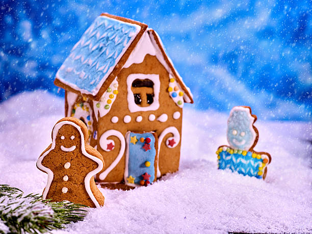 istock Christmas gingerbread house in snow on blue background. 629515440