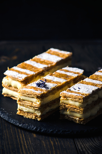 Millefeuille, french pastry on a wooden dark background