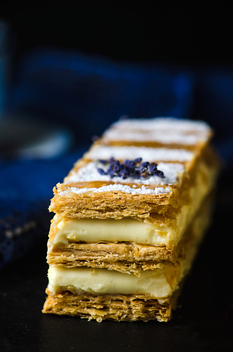 Millefeuille, french pastry on a wooden dark background