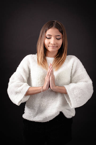 istock Beautiful woman doing different expressions in different sets of clothes: prayer 629517022
