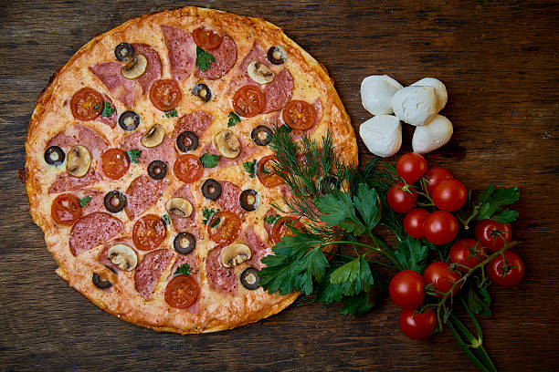 istock Pizza and different ingredients in it.  Dark background. 629527482