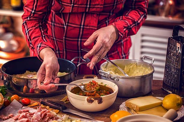 istock Preparing Baked Crepes Pancakes with Ham and Tomatoes 629528982