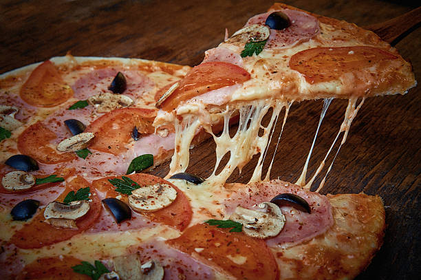 istock Pizza and different ingredients in it.  Dark background. 629529344