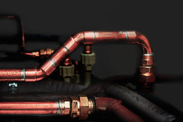 istock Copper and plastic pipes in a dark 629531532