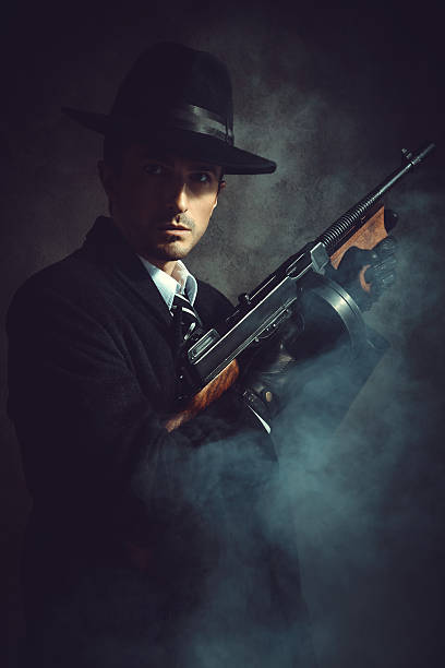 Gangster Portrait of a gangster with Tommy Gun organized crime photos stock pictures, royalty-free photos & images
