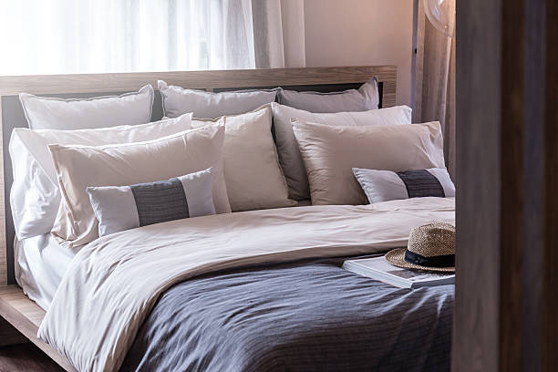istock Bed maid-up with clean white pillows and bed sheets 629533188