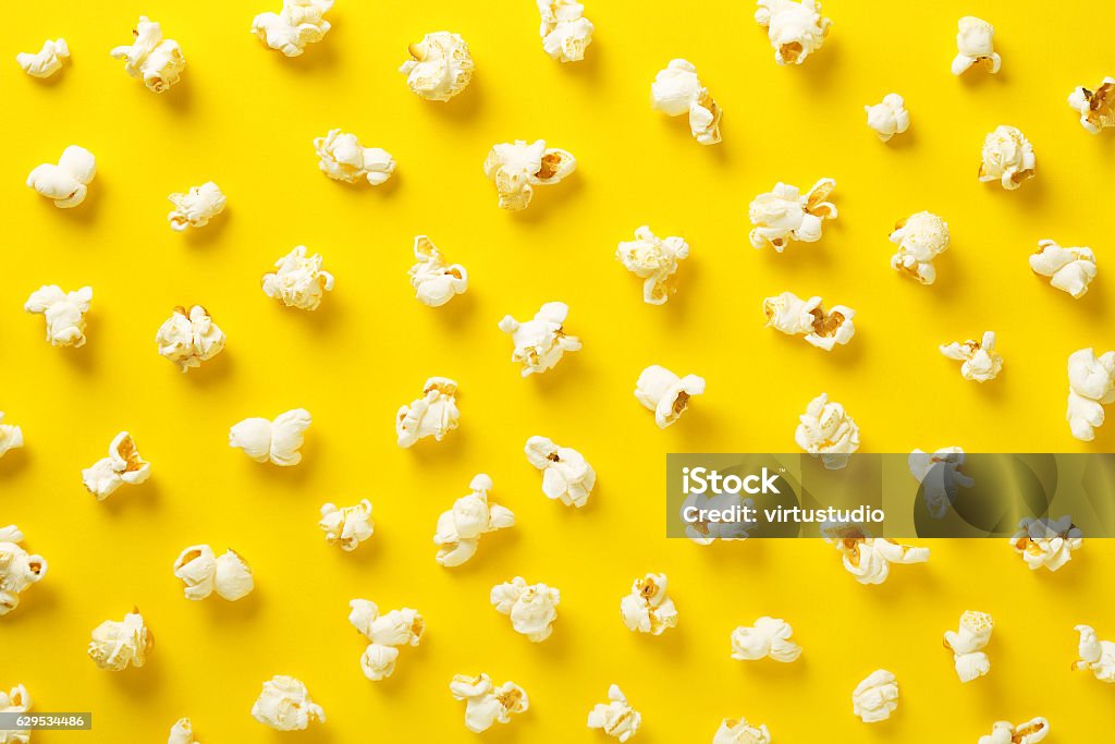 Popcorn pattern on yellow background. Top view Popcorn Stock Photo