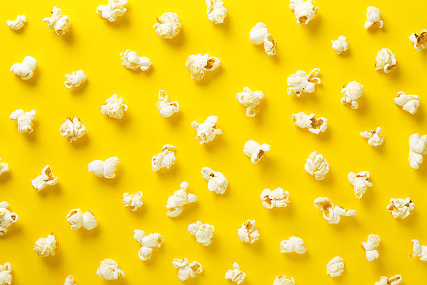 Popcorn pattern on yellow background. Top view stock photo