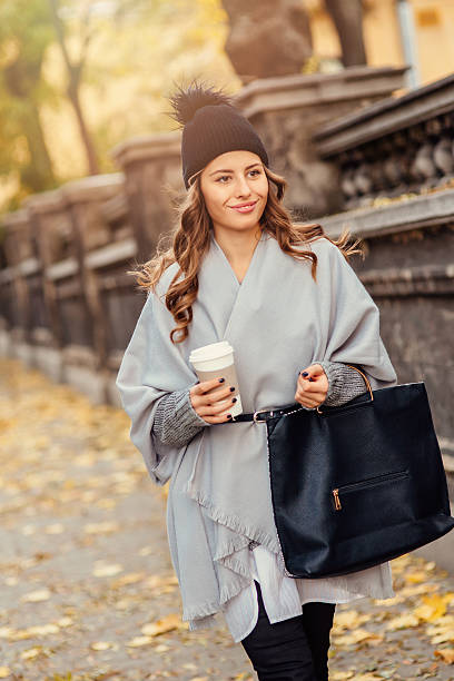 istock Young woman drinking coffee outdoors 629534616