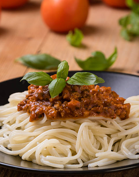 istock spaghetti bolognese on black plate 629555994