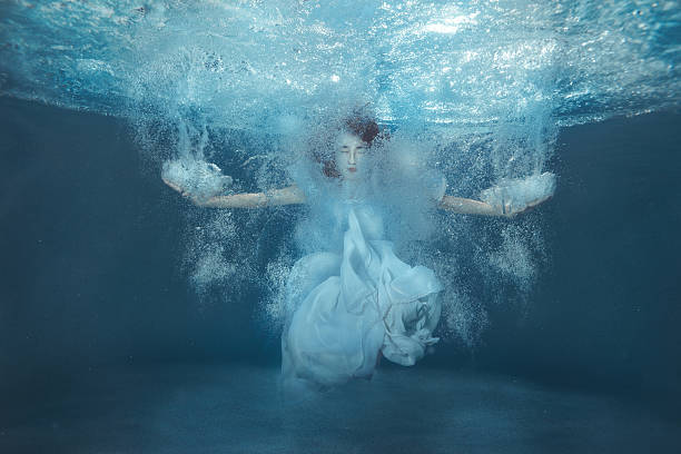 istock Girl in the pool among the bubbles. 629556084