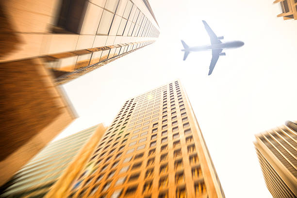 istock Airplane low pass over the business district 629556786