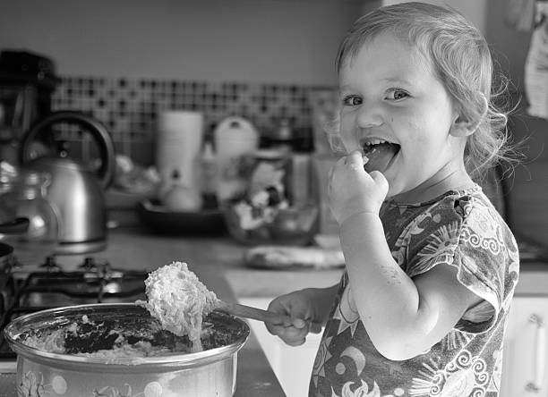 istock Happy toddler baking and eating with cheerful eyes 629557376