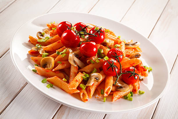 istock Penne with pesto sauce and vegetables 629557706