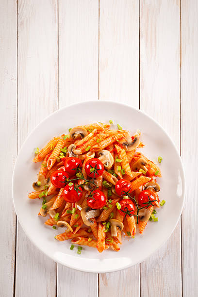 istock Penne with pesto sauce and vegetables 629557838