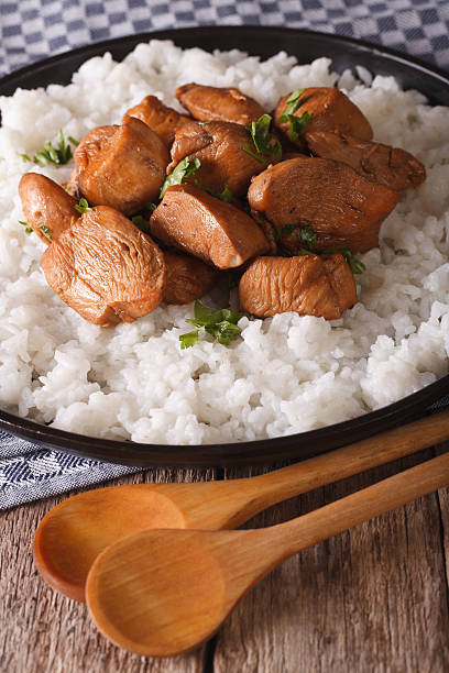 istock Adobo Chicken with a side dish of rice close-up. Vertical 629558512