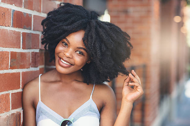 Portrait of a happy young woman posing confidently in an urban setting