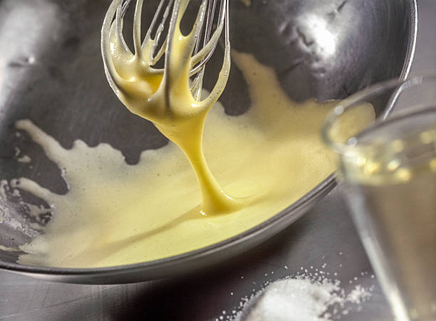 Cook whipping a preparation Dripping whisk, stainless steel mixing bowl hollandaise sauce stock pictures, royalty-free photos & images