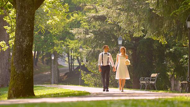istock Bride and groom walking together 629565032