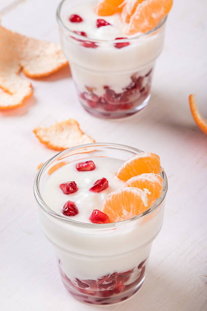 istock yogurt with pomegranate seeds and mandarin orange 629565898