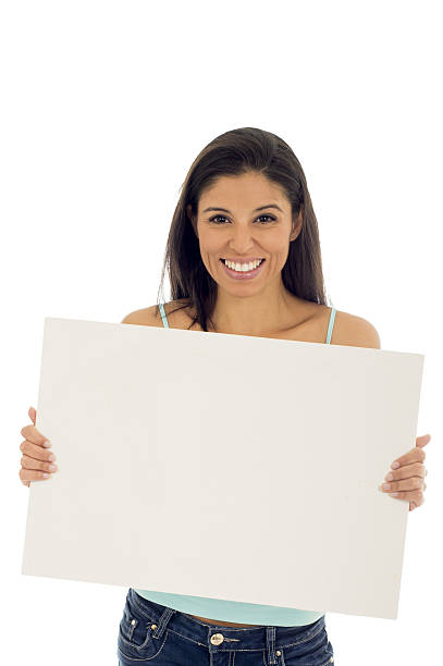 istock attractive happy hispanic woman holding blank billboard with copy space 629566456