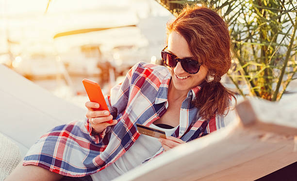 istock Woman on a vacation shopping online 629567994
