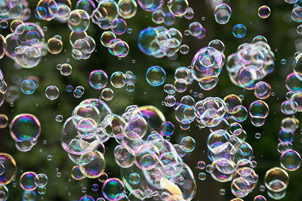 istock Movement colorful soap bubbles floating in the air. 629568230