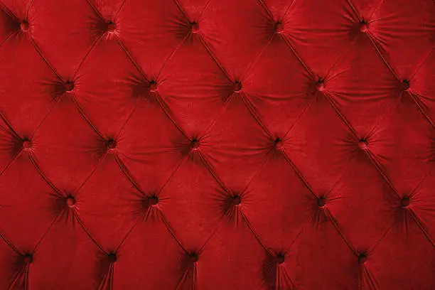 Photo of Red capitone tufted fabric upholstery texture