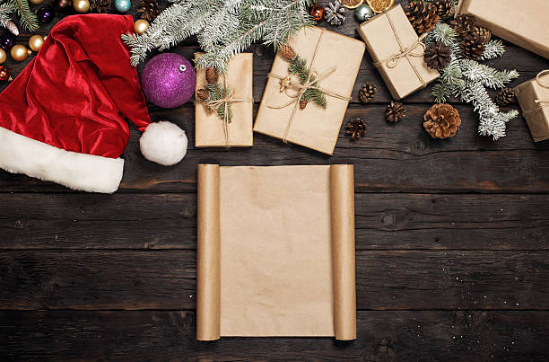 istock Christmas background with a blank paper on dark wooden table 629569124